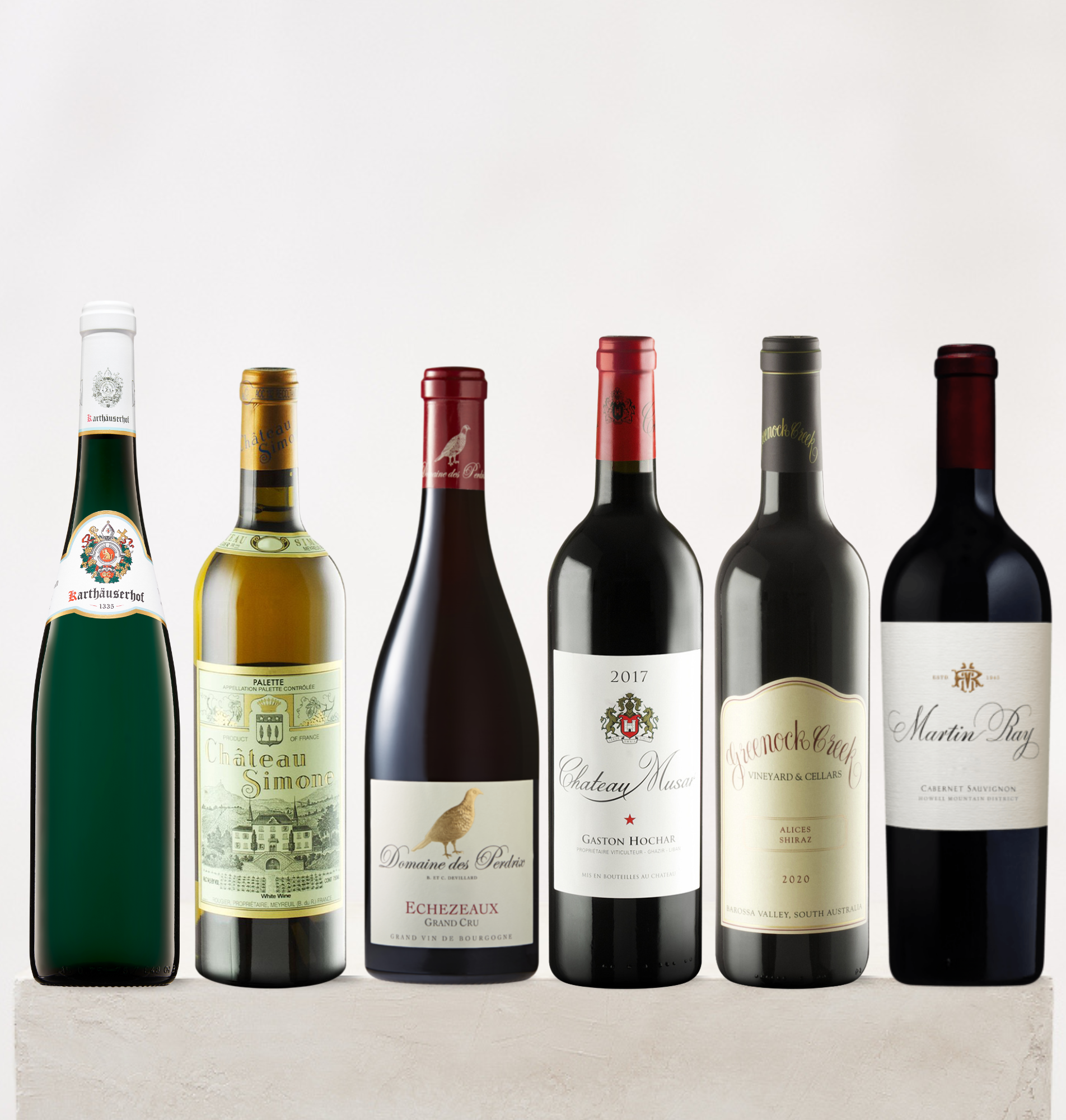 Collection of wine bottles with various labels on a light background